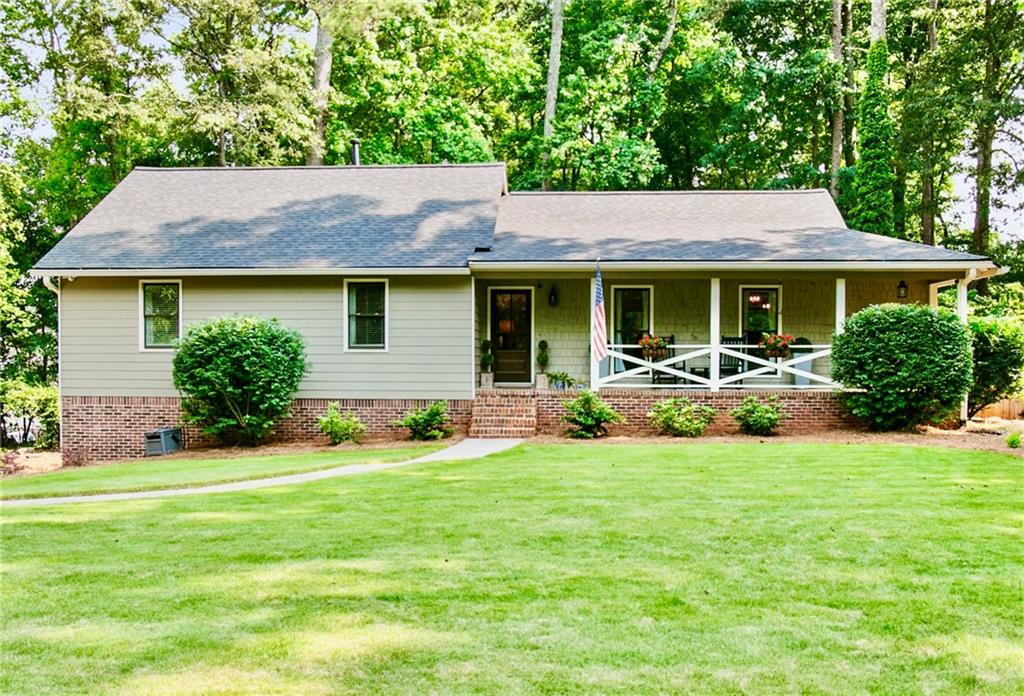 3255 Sutcliffe Ridge Northwest Marietta, GA 30064 - Photo 1 of 1 a backyard of a house with table and chairs