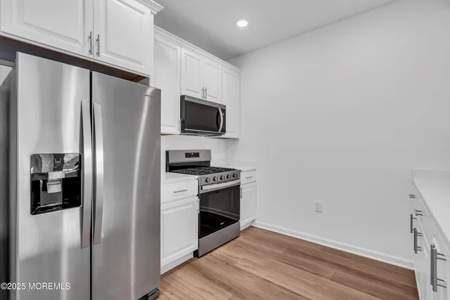 a kitchen with stainless steel appliances a refrigerator stove and microwave