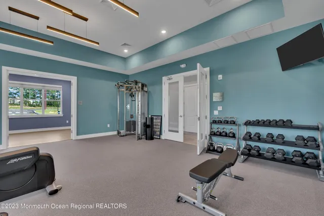 a room with gym equipment and a flat screen tv