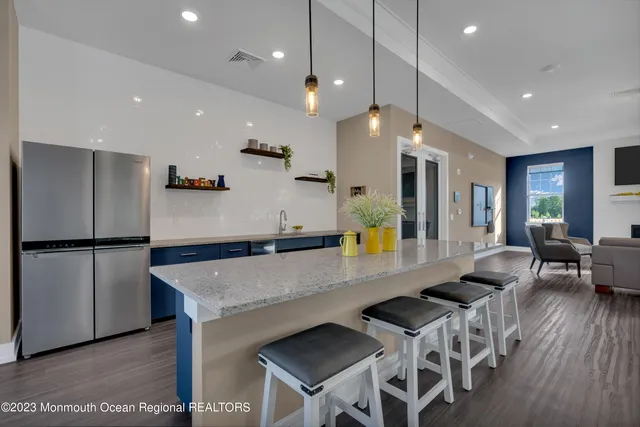 a large kitchen with lots of counter space and refrigerator