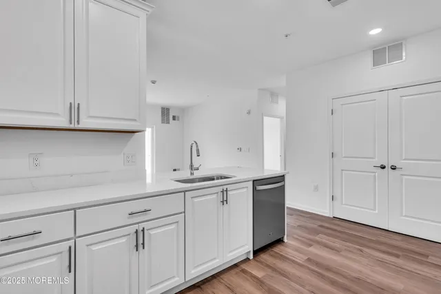a kitchen with white cabinets and a sink
