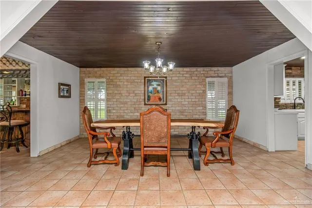 a dining room with furniture and chandelier