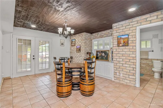 a dining room with furniture and chandelier