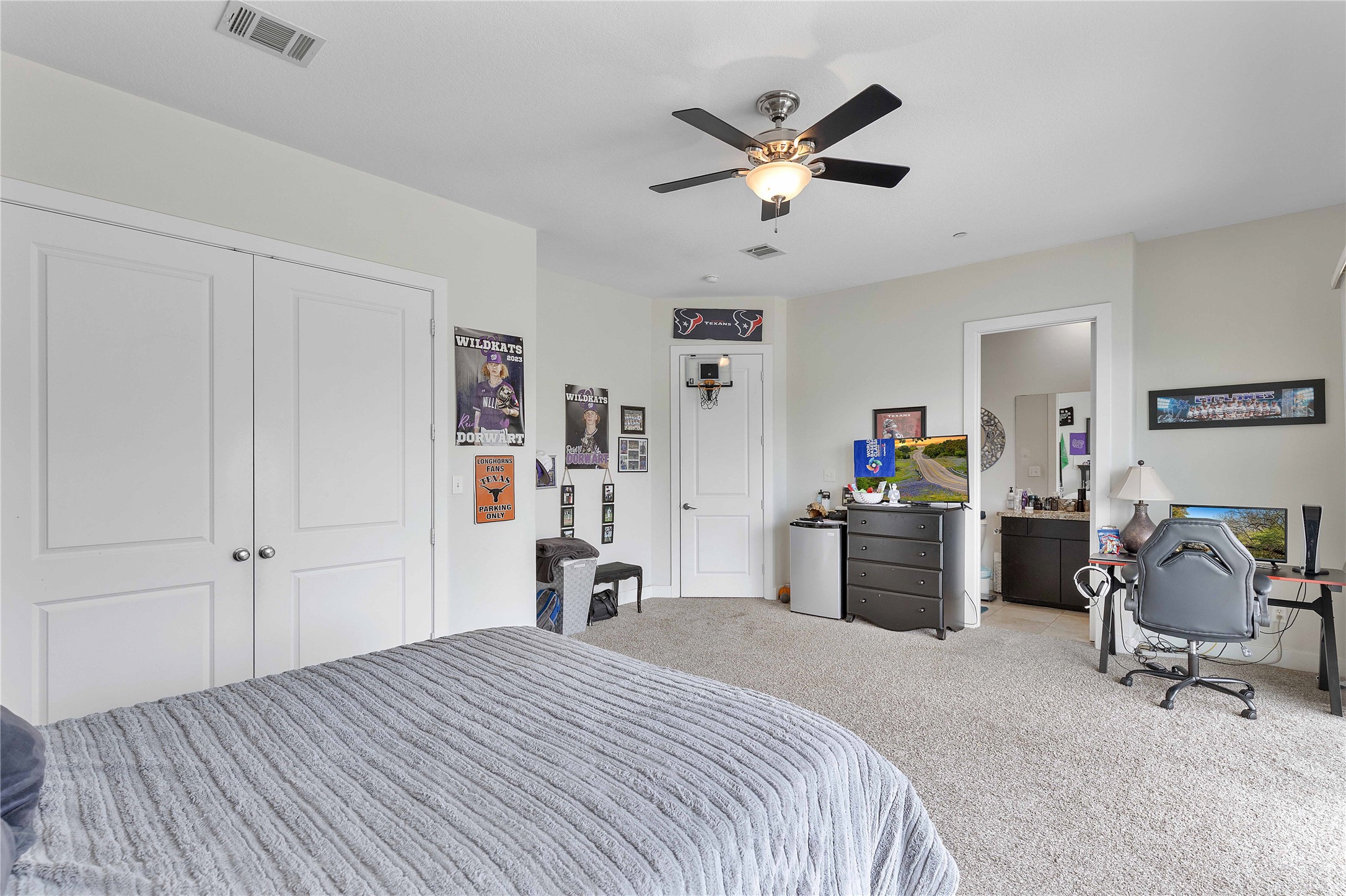 11434 Ketch Court Willis, TX 77318 - Photo 27 of 50 a bedroom with a bed and a chandelier