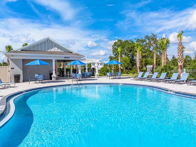 an aerial view of a swimming pool patio and outdoor seating