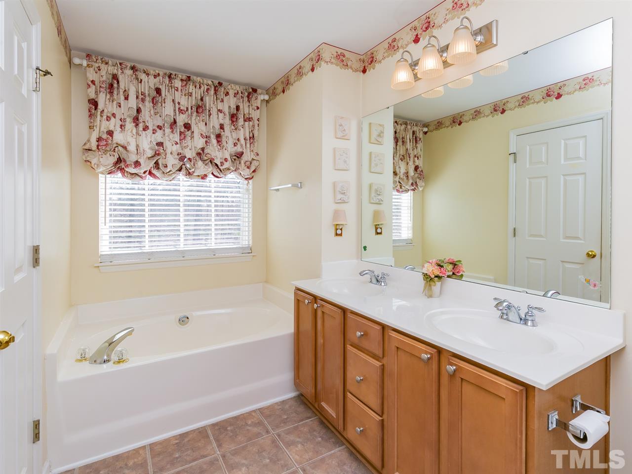2520 Spruce Shadows Lane Raleigh, NC 27614 - Photo 12 of 25 a bathroom with a tub sink and mirror