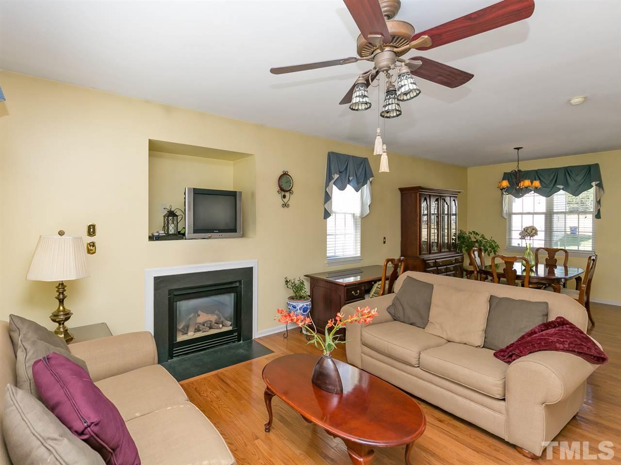 2520 Spruce Shadows Lane Raleigh, NC 27614 - Photo 3 of 25 a living room with furniture fireplace and a window
