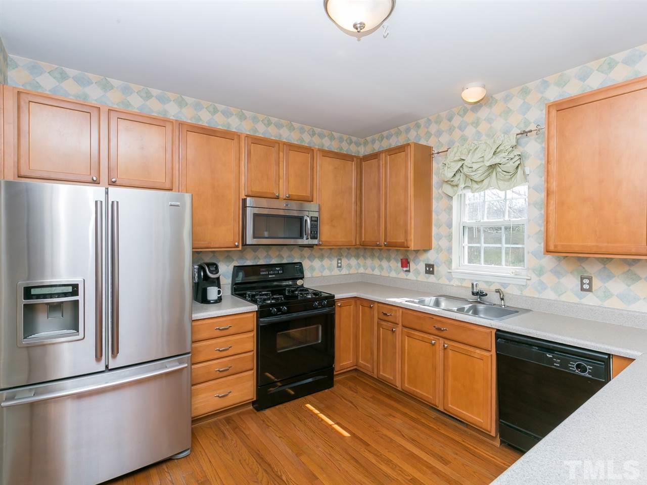 2520 Spruce Shadows Lane Raleigh, NC 27614 - Photo 6 of 25 a kitchen with stainless steel appliances granite countertop a refrigerator a sink dishwasher a stove and white countertops with wooden floor