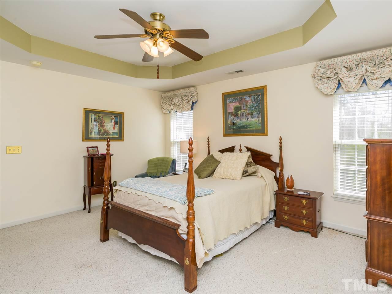 2520 Spruce Shadows Lane Raleigh, NC 27614 - Photo 10 of 25 a bedroom with a bed and a chandelier