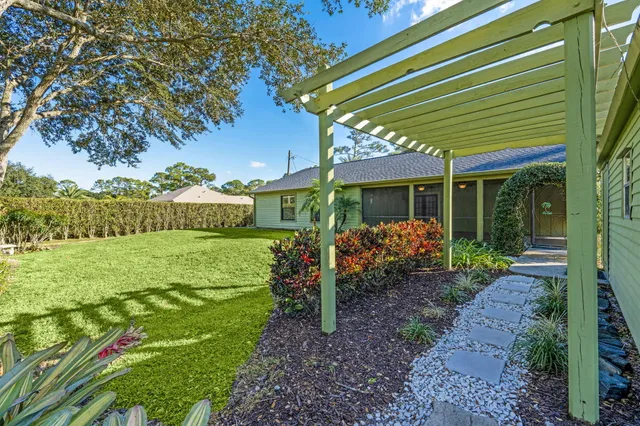 a front view of a house with a yard garage and outdoor seating
