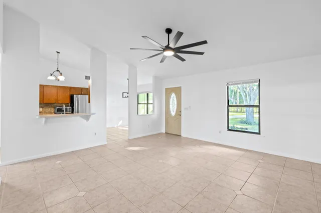 a kitchen with refrigerator and cabinets