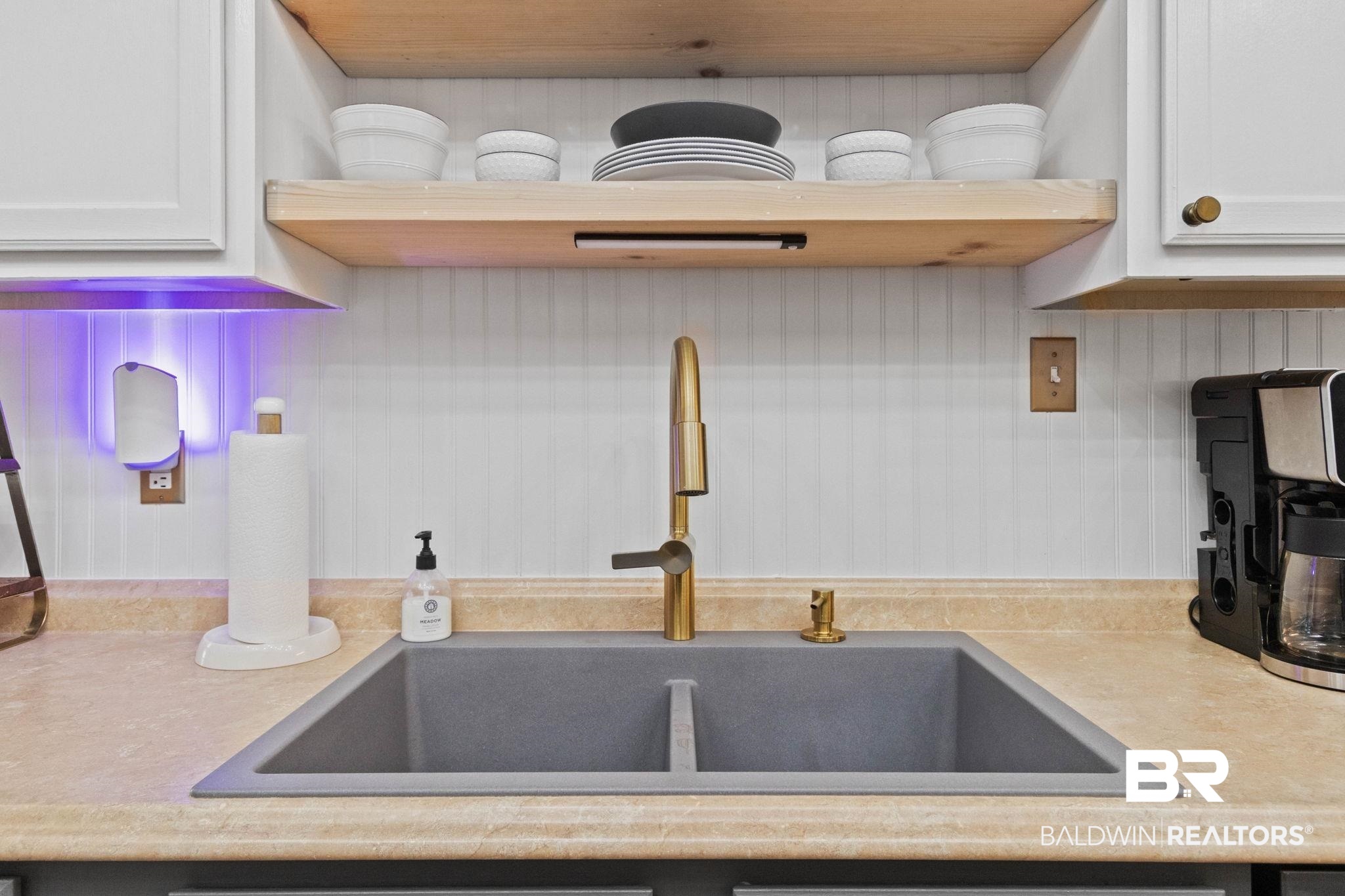 524 Ariel Avenue Foley, AL 36535 - Photo 12 of 37 Double basin sink with a gold-tone high-arc faucet, light-colored countertops, and white beadboard paneling