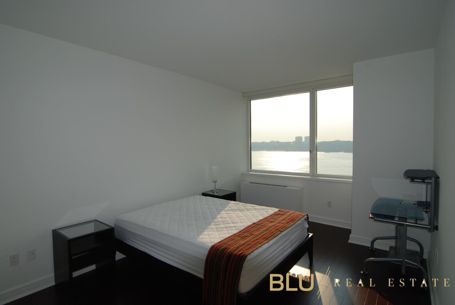 100 Riverside Boulevard, Unit 16E Manhattan, NY 10069 - Photo 4 of 11 a room with a bed and a window