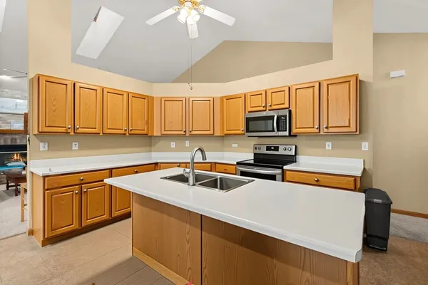 a kitchen with a table chairs refrigerator and microwave