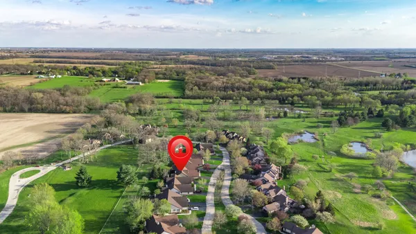 an aerial view of a golf course with parking space