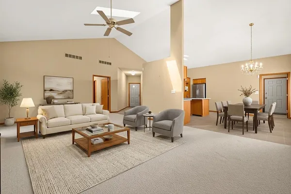 a living room with furniture and a floor to ceiling window