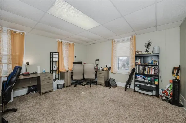 a view of a livingroom with workspace and a window
