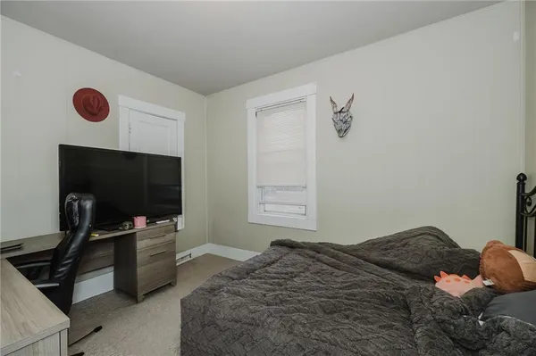 a bedroom with a bed and flat screen tv