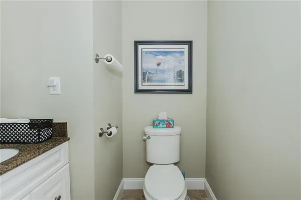 a white toilet sitting next to a bathroom sink