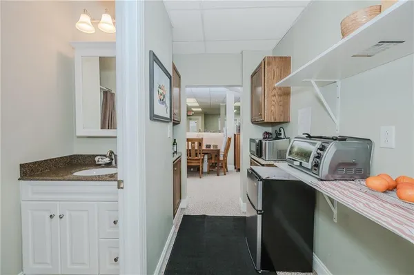 a kitchen with a sink a stove and cabinets