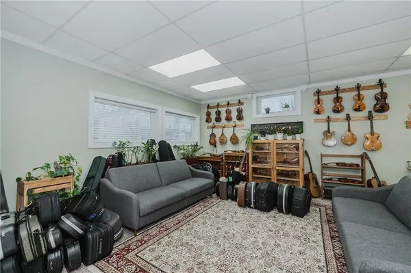 a living room with furniture a rug and a flat screen tv