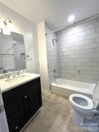 a bathroom with a sink a toilet and bathtub