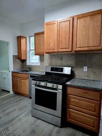 a stove top oven sitting inside of a kitchen