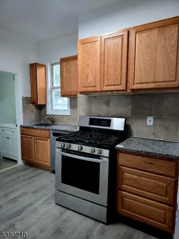 a stove top oven sitting inside of a kitchen