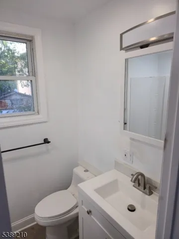 a white toilet sitting next to a bathroom sink