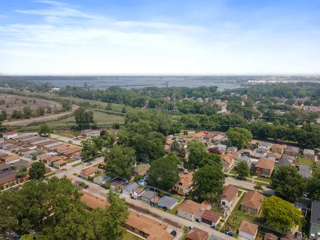an aerial view of residential house with outdoor space and trees around