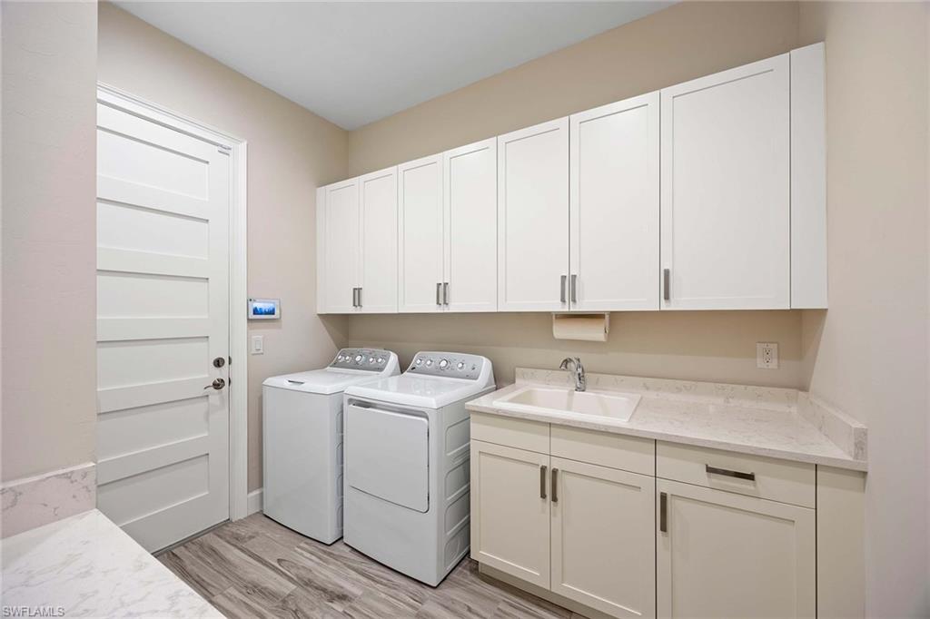 5626 Elbow Avenue Naples, FL 34113 - Photo 27 of 48 a view of a storage and utility room with closet dryer and washer