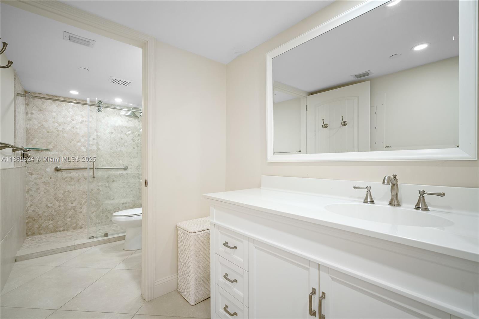9341 Collins Avenue, Unit 205 Surfside, FL 33154 - Photo 13 of 33 a bathroom with a sink a toilet and shower