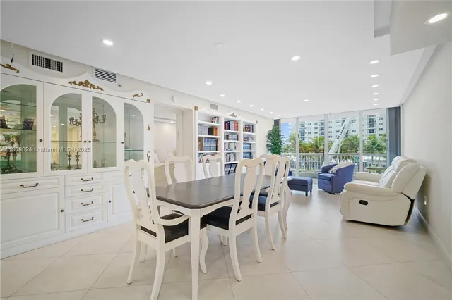 a living room with furniture a large window and white walls
