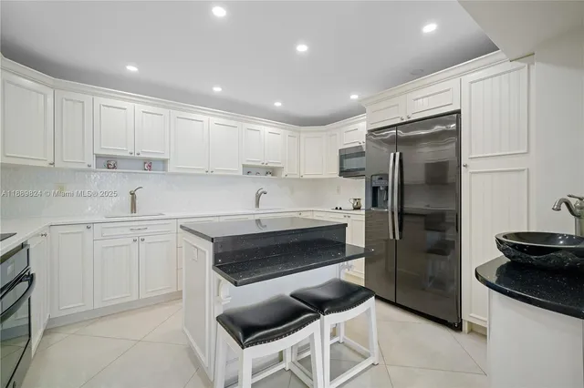 a kitchen with a sink stainless steel appliances and cabinets
