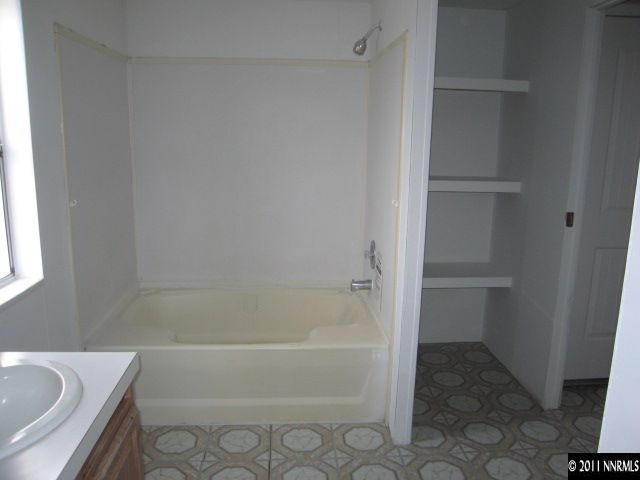 4833 Lynnie Lane Fallon, NV 89406 - Photo 8 of 13 a bathroom with a bathtub and shower