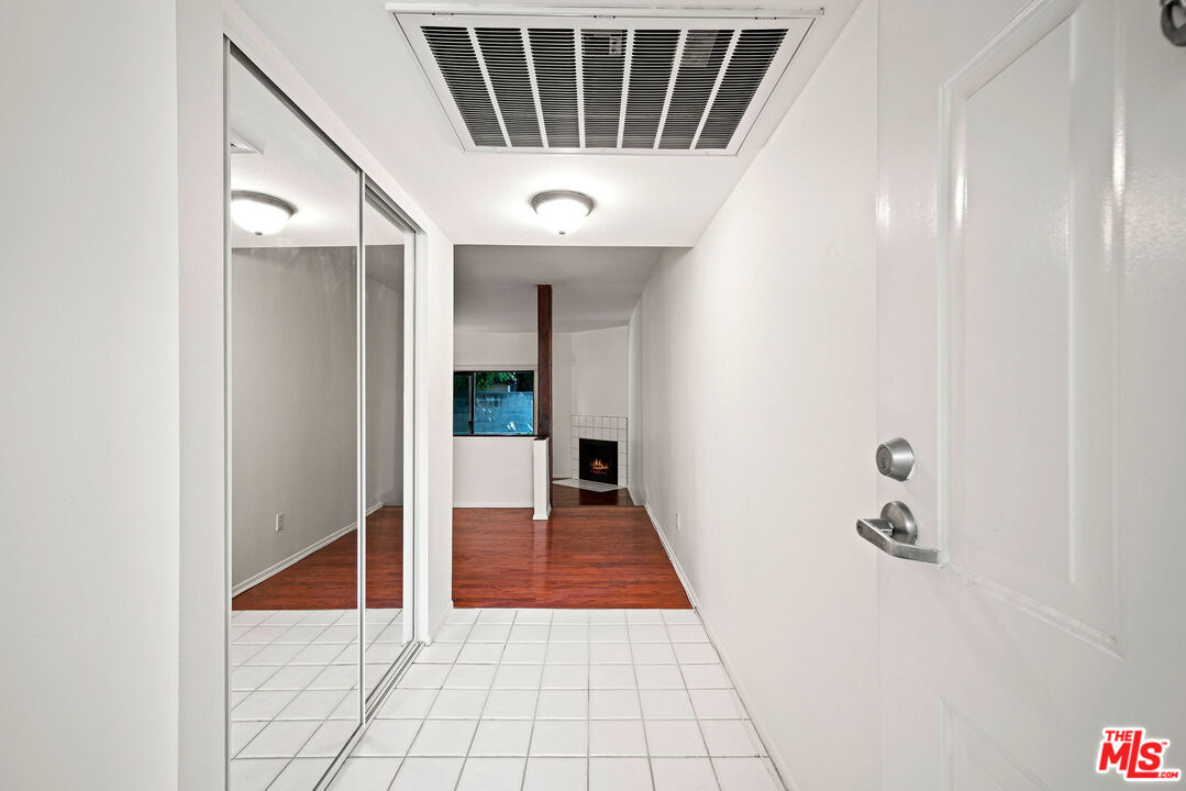 2491 Purdue Avenue, Unit 105 Los Angeles, CA 90064 - Photo 11 of 36 a view of a hallway with wooden floor and staircase