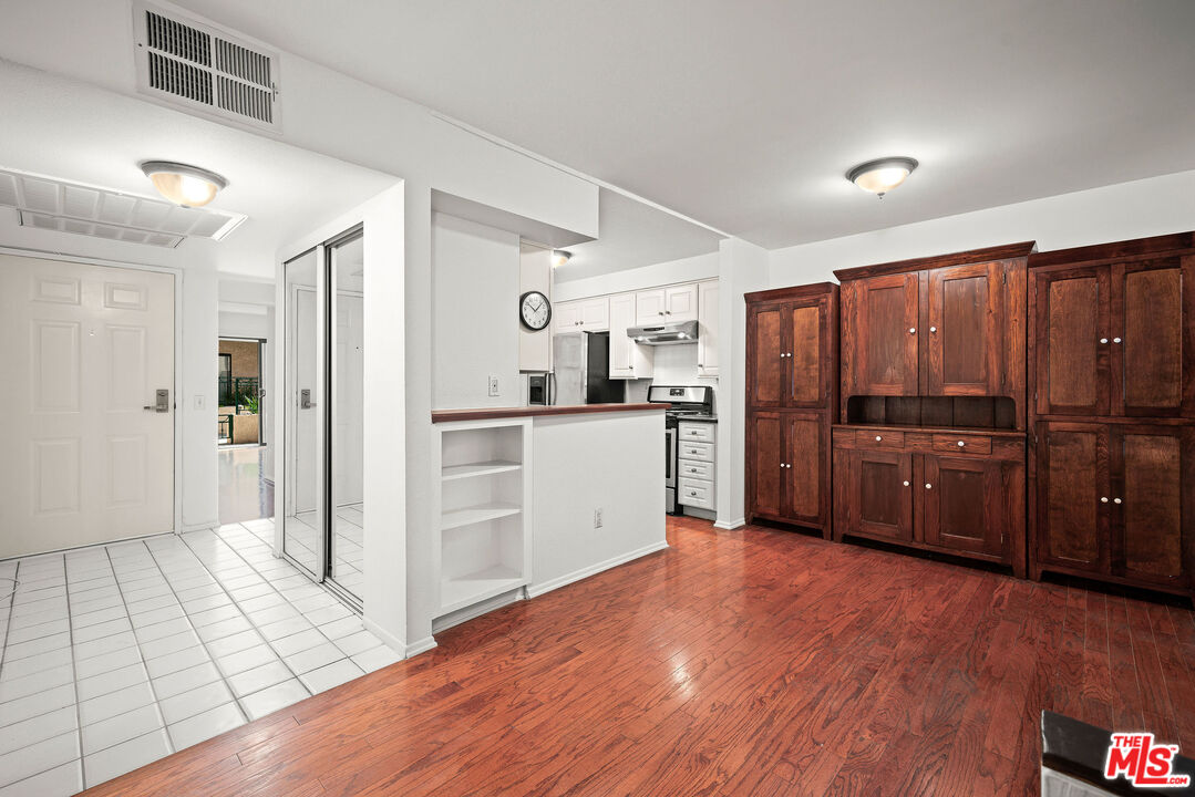 2491 Purdue Avenue, Unit 105 Los Angeles, CA 90064 - Photo 12 of 36 a kitchen with granite countertop a refrigerator and a sink