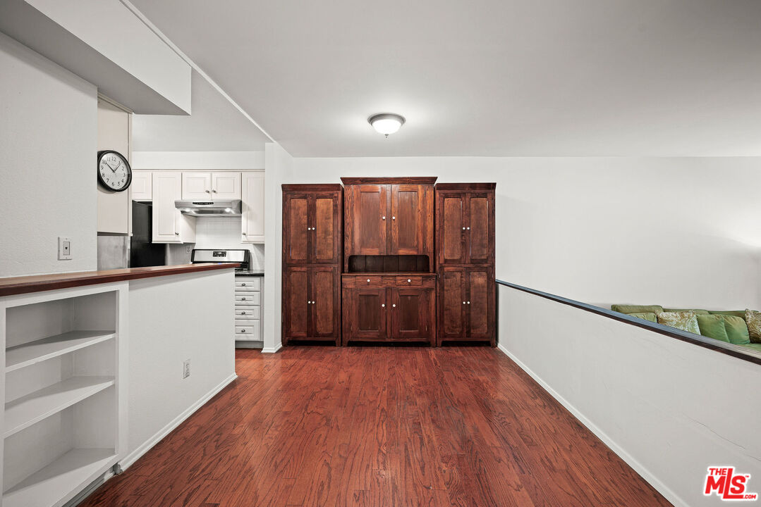 2491 Purdue Avenue, Unit 105 Los Angeles, CA 90064 - Photo 13 of 36 a kitchen with granite countertop wooden floors and stainless steel appliances