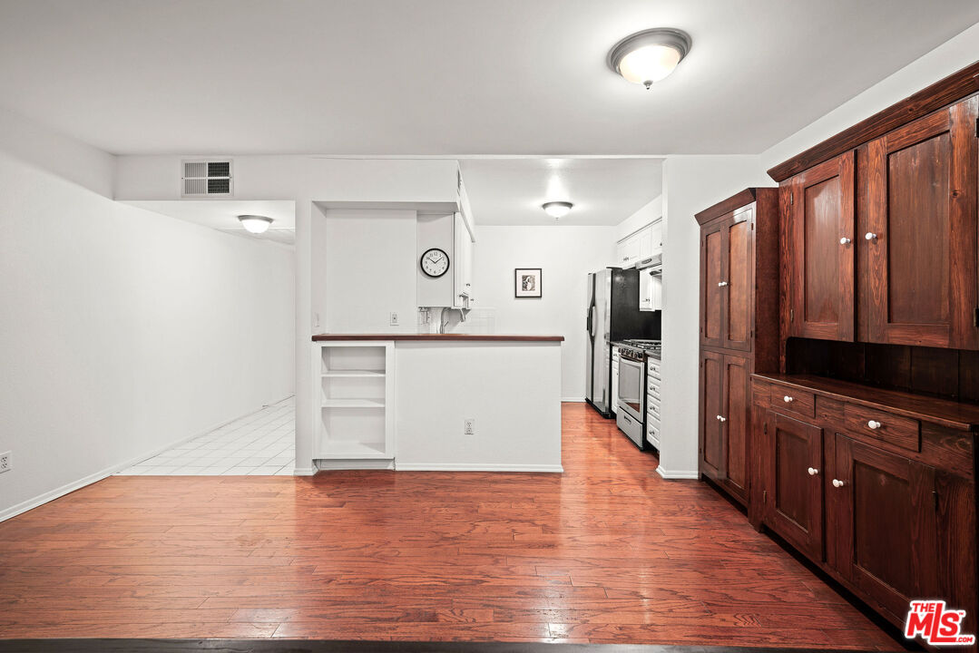 2491 Purdue Avenue, Unit 105 Los Angeles, CA 90064 - Photo 14 of 36 a view of a kitchen with wooden floor and electronic appliances