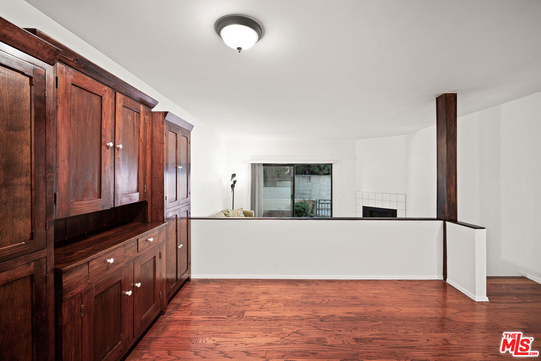 2491 Purdue Avenue, Unit 105 Los Angeles, CA 90064 - Photo 15 of 36 a view of a kitchen with wooden floor and electronic appliances