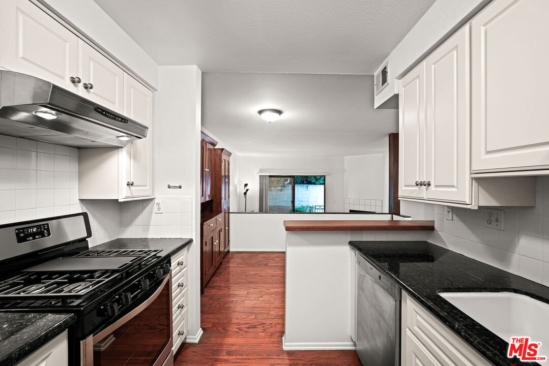 2491 Purdue Avenue, Unit 105 Los Angeles, CA 90064 - Photo 16 of 36 a kitchen with a stove and a sink