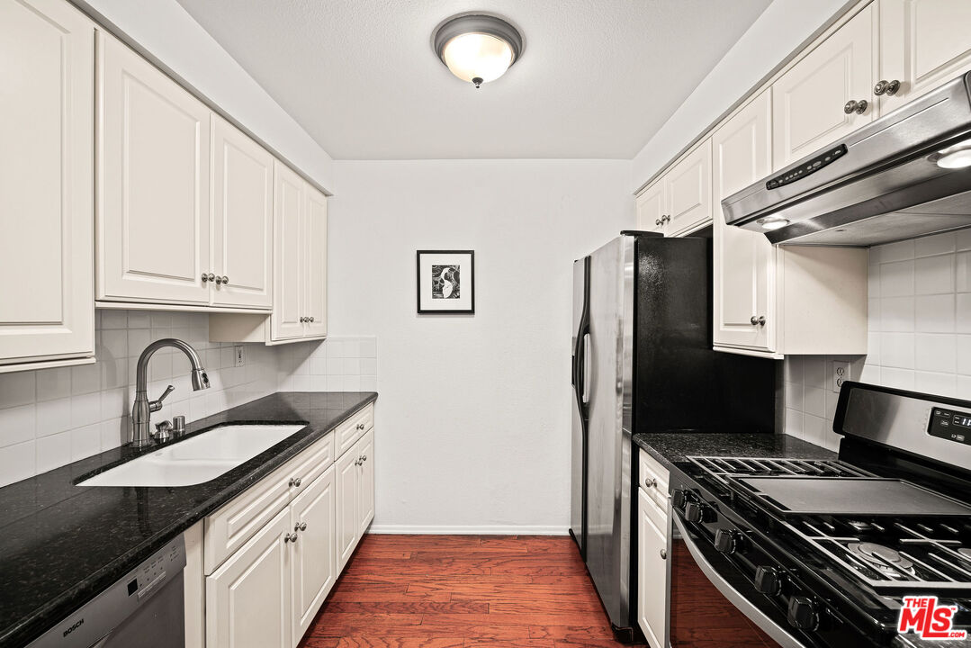 2491 Purdue Avenue, Unit 105 Los Angeles, CA 90064 - Photo 17 of 36 a kitchen with stainless steel appliances granite countertop a sink stove and refrigerator