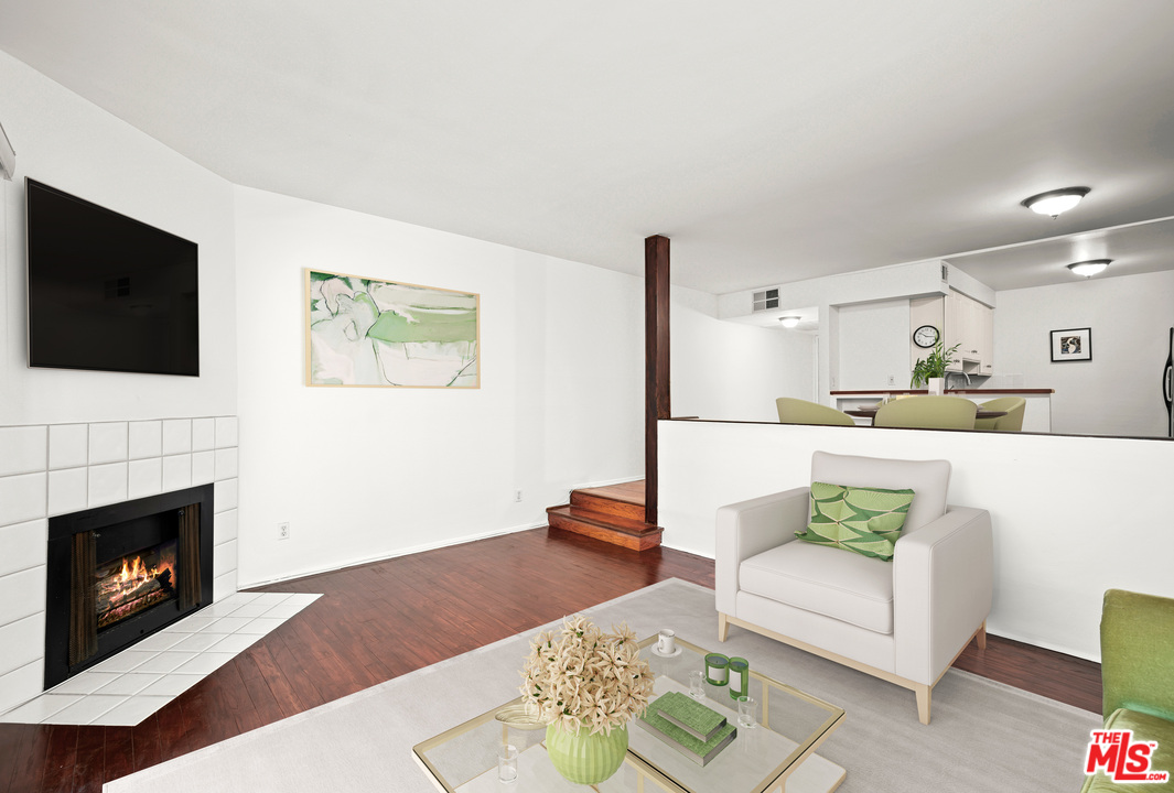 2491 Purdue Avenue, Unit 105 Los Angeles, CA 90064 - Photo 19 of 36 a living room with furniture and a fireplace