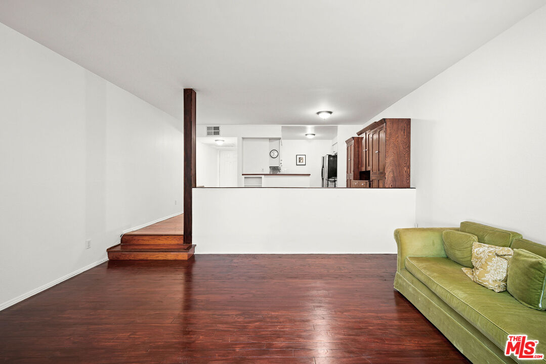 2491 Purdue Avenue, Unit 105 Los Angeles, CA 90064 - Photo 20 of 36 a living room with stainless steel appliances kitchen island granite countertop a refrigerator and a wooden floor