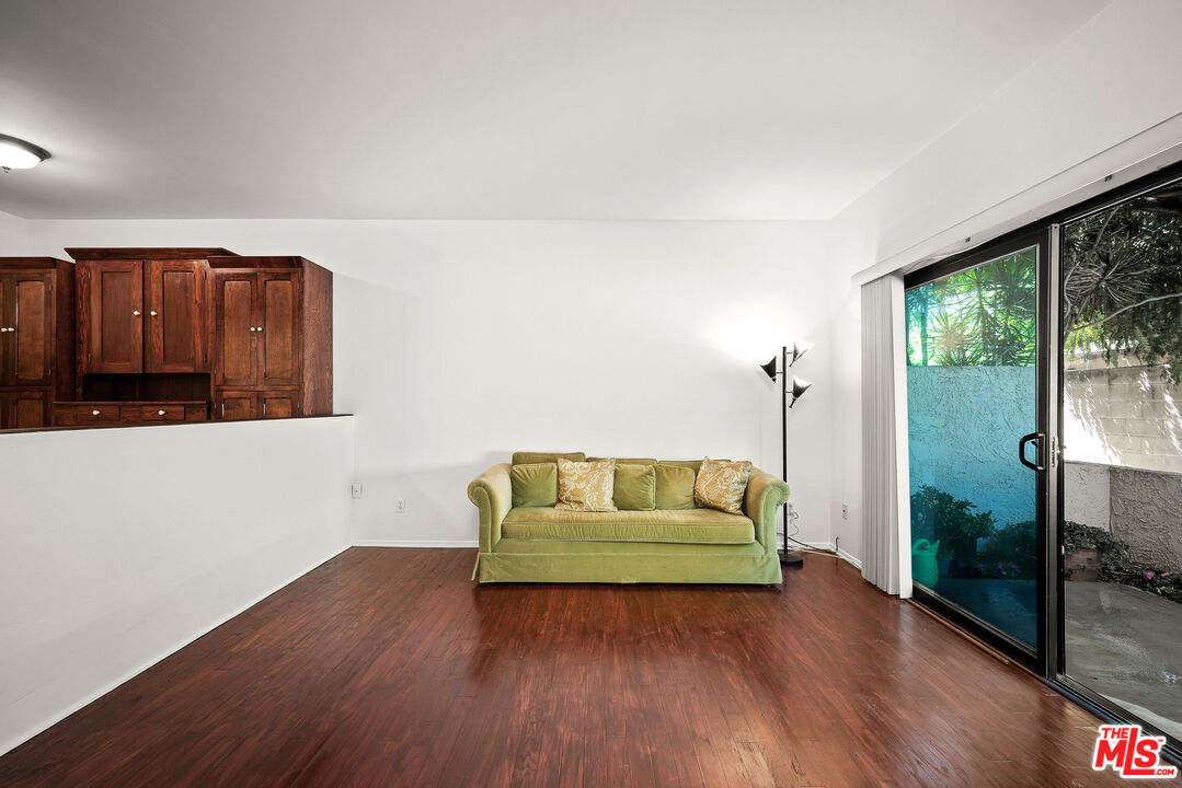2491 Purdue Avenue, Unit 105 Los Angeles, CA 90064 - Photo 23 of 36 a living room with couch and a wooden floor