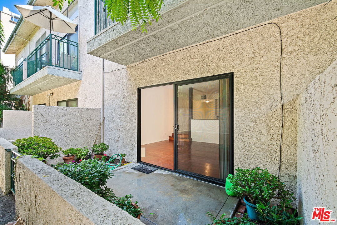 2491 Purdue Avenue, Unit 105 Los Angeles, CA 90064 - Photo 24 of 36 a front view of a house with a garden