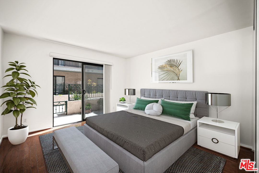 2491 Purdue Avenue, Unit 105 Los Angeles, CA 90064 - Photo 29 of 36 a bedroom with a large bed and a potted plant