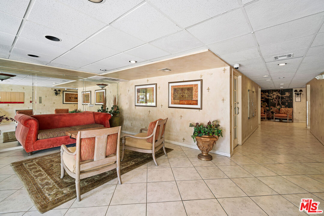 2491 Purdue Avenue, Unit 105 Los Angeles, CA 90064 - Photo 33 of 36 a living room with furniture a dining table and chairs