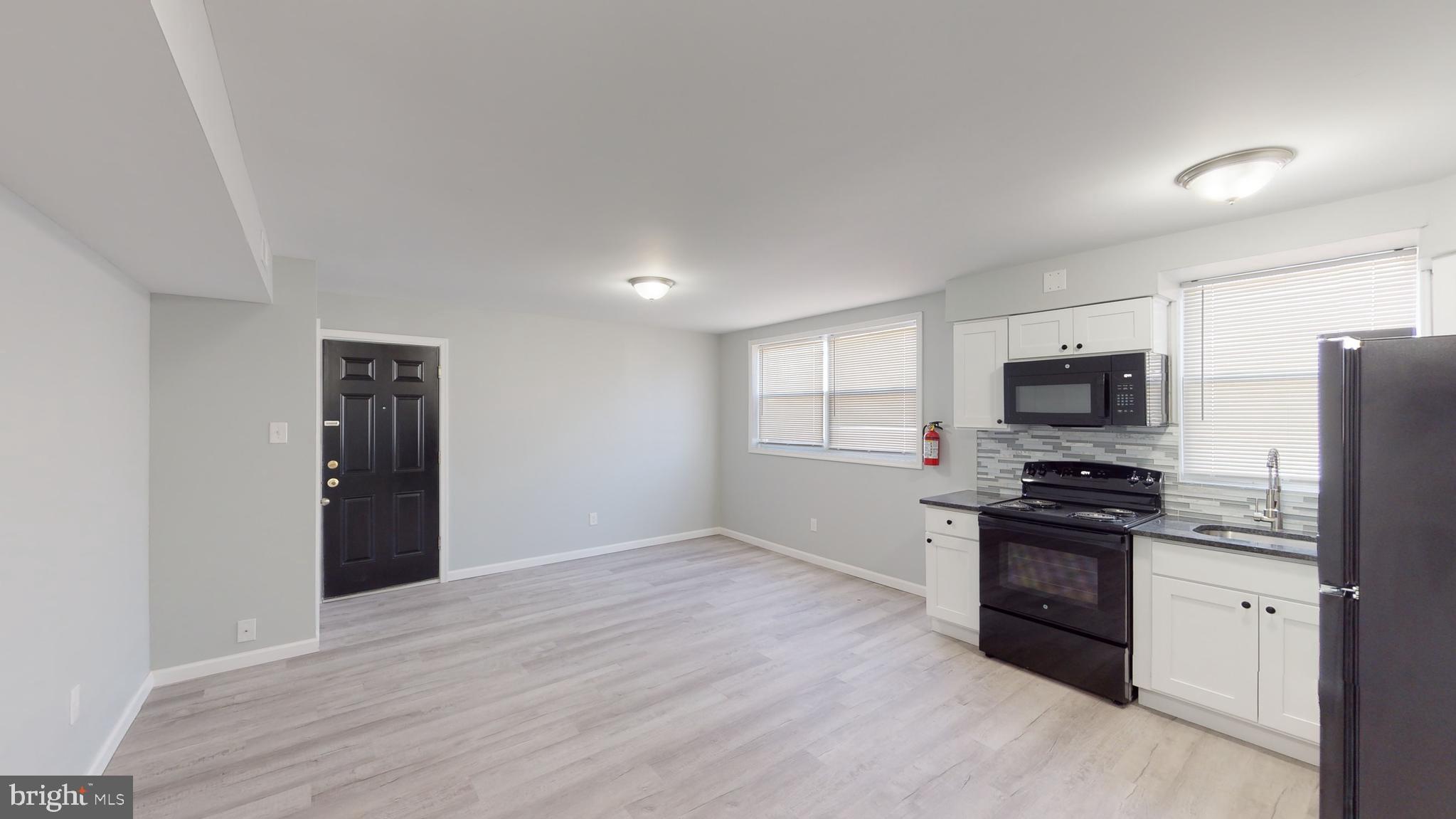 910 Gateway Boulevard, Unit C2 Westville, NJ 08093 - Photo 8 of 11 a kitchen with stainless steel appliances granite countertop a refrigerator stove and sink