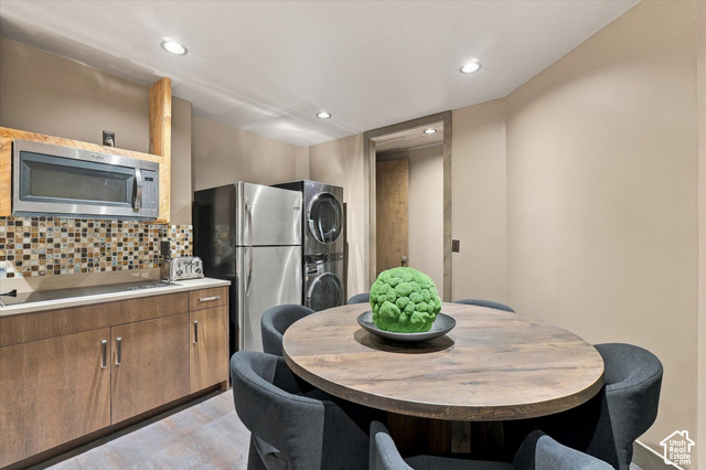 5936 Triple Crown Trail Oakley, UT 84055 - Photo 31 of 57 Compact kitchen area featuring stainless steel appliances, mosaic tile backsplash, wood-finish cabinetry, and recessed lighting